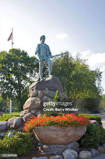 statue of man with gun atop rock. - lexington massachusetts stock pictures, royalty-free photos & images