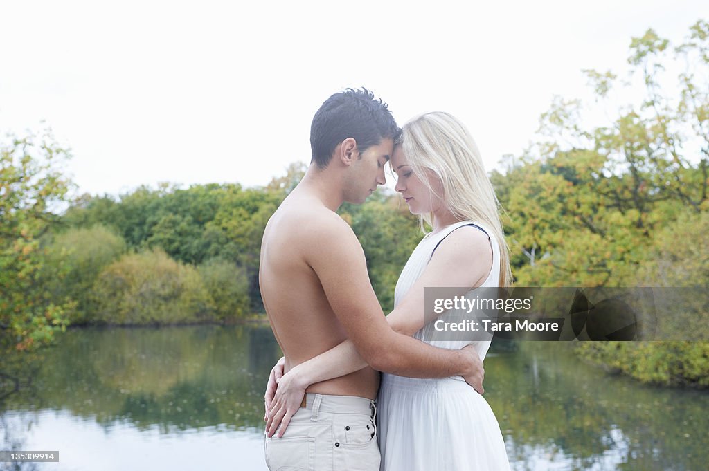 Young man in embrace with young woman in park