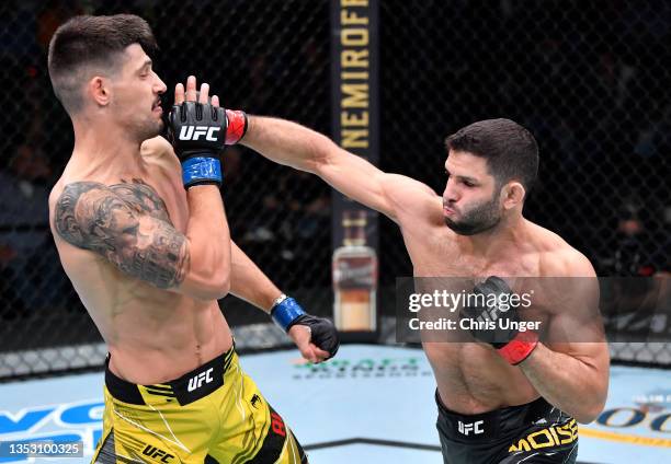 Thiago Moises of Brazil punches Joel Alvarez of Spain in a lightweight fight during the UFC Fight Night event at UFC APEX on November 13, 2021 in Las...