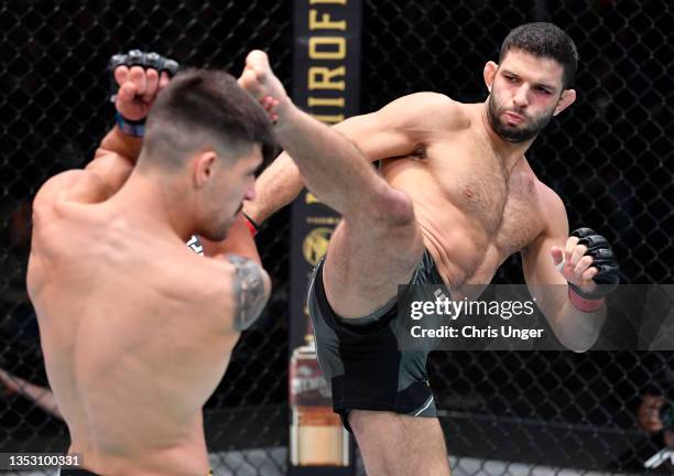 Thiago Moises of Brazil kicks Joel Alvarez of Spain in a lightweight fight during the UFC Fight Night event at UFC APEX on November 13, 2021 in Las...