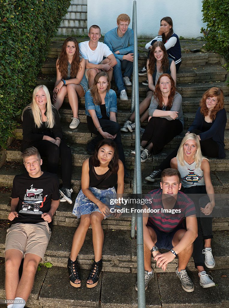 Large group of teens sitting together at steeps