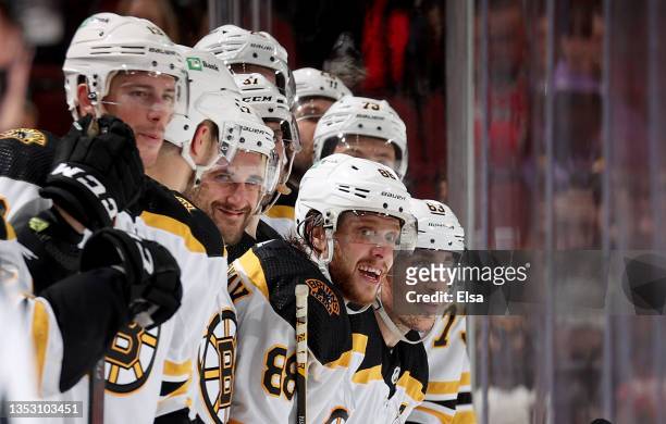 David Pastrnak and Brad Marchand of the Boston Bruins along with the rest of the bench reacts near the end of the game against the New Jersey Devils...