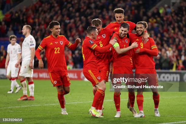 Ben Davies of Wales celebrates after scoring their side's fourth goal with Joe Rodon and Tyler Roberts during the 2022 FIFA World Cup Qualifier match...