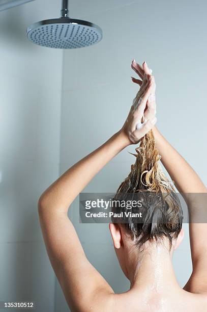 back shot of young woman washing hair in shower - douche savon photos et images de collection