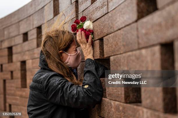 On the 20th anniversary of the crash of American Airlines Flight 587, a relative of one of the victims is overcome with emotion at the memorial in...