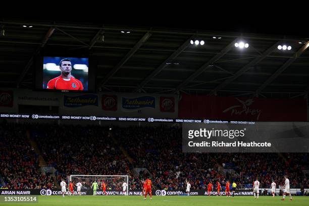 Fans applaud as the LED screen displays an image of Gary Speed MBE during the 2022 FIFA World Cup Qualifier match between Wales and Belarus at...