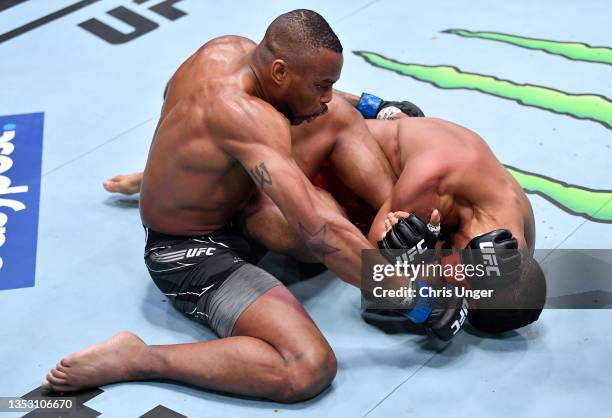 Khaos Williams punches to defend a submission attempt by Miguel Baeza in a welterweight fight during the UFC Fight Night event at UFC APEX on...