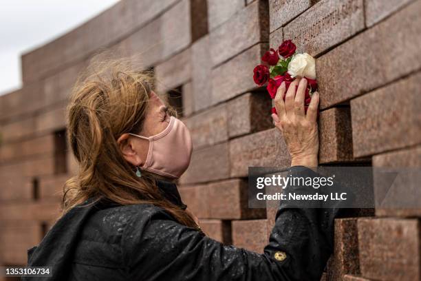 On the 20th anniversary of the crash of American Airlines Flight 587, a relative of one of the victims grieves at the memorial in Belle Harbor, New...