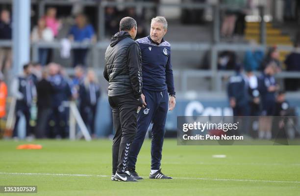 Bristol Rovers first team coach Kevin Bond talks to Northampton Town assistant manager Colin Calderwood prior to the Sky Bet League Two match between...