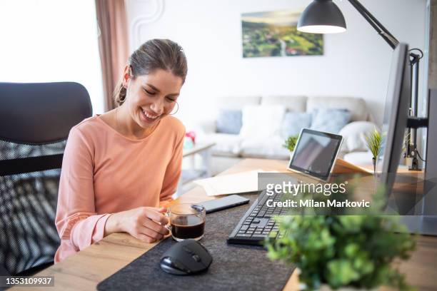 a young woman works from her home. - government employee stock pictures, royalty-free photos & images