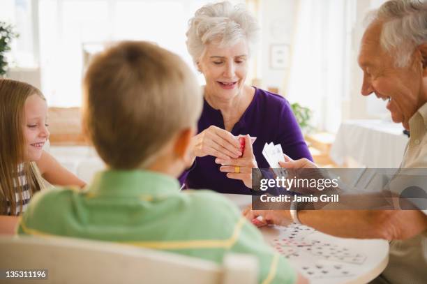 grandparents playing card game with grandchildren - senior men playing cards stock pictures, royalty-free photos & images