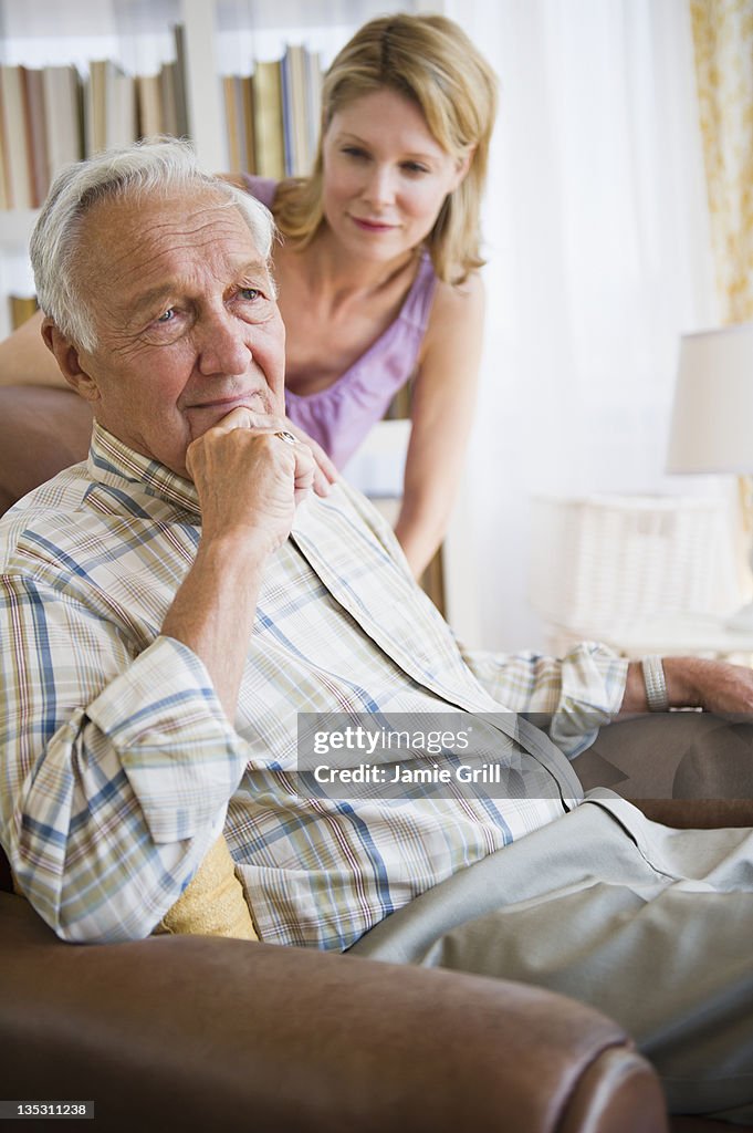 Pensive father, grown daughter concerned