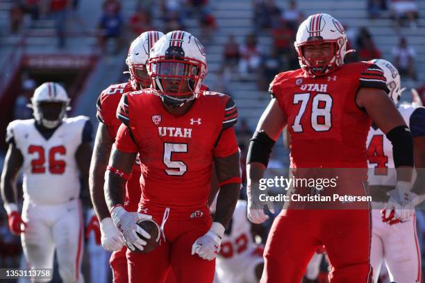 Running back TJ Pledger of the Utah Utes reacts after scoring a two-yard rushing touchdown against the Arizona Wildcats during the fourth quarter of...