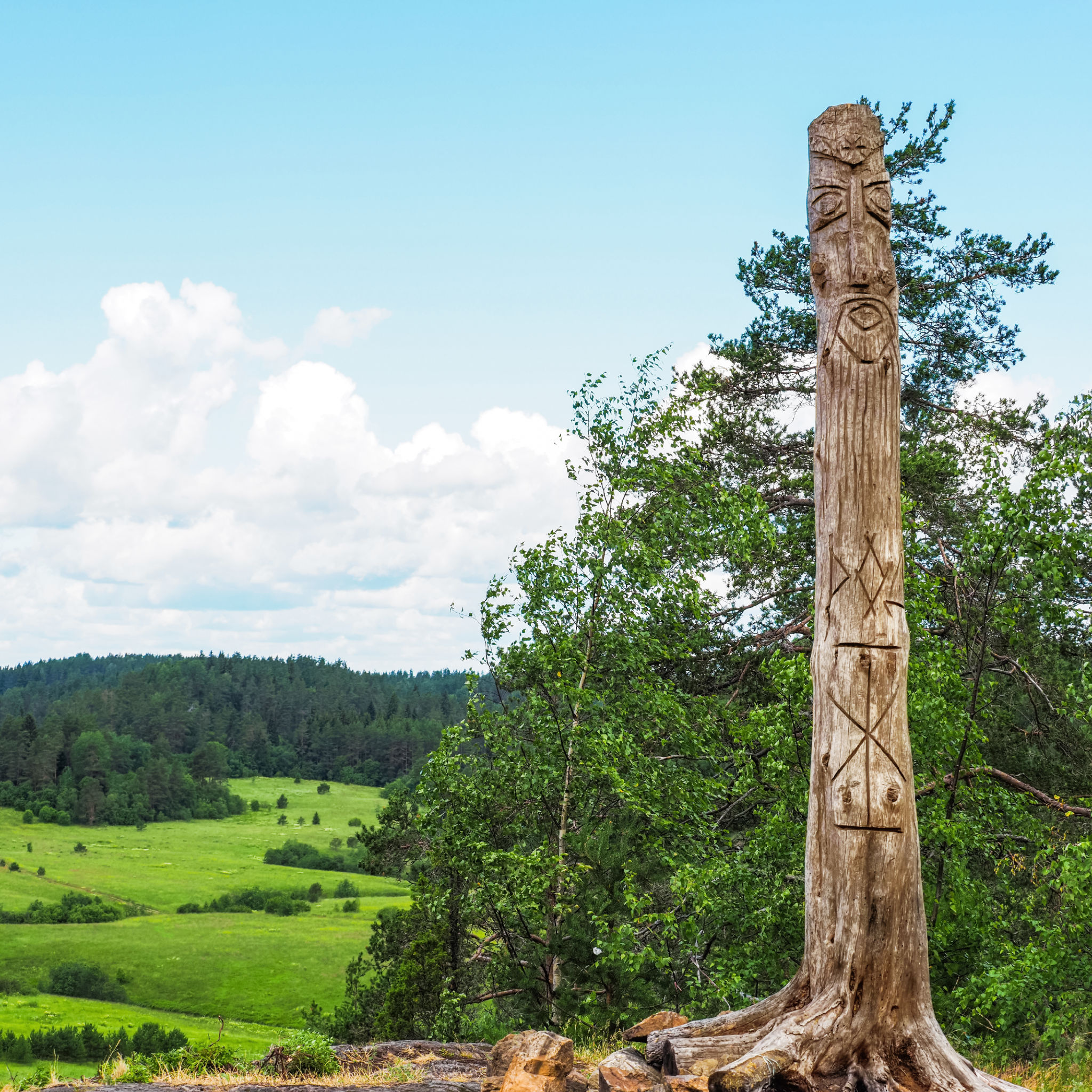 Pagan temple on Akhmavaara rock with wooden idol. Image of pagan god is carved from trunk tree, Karelia, Russia Pagan temple on Akhmavaara rock with wooden idol. Image of pagan god is carved from trunk tree, Karelia, Russia