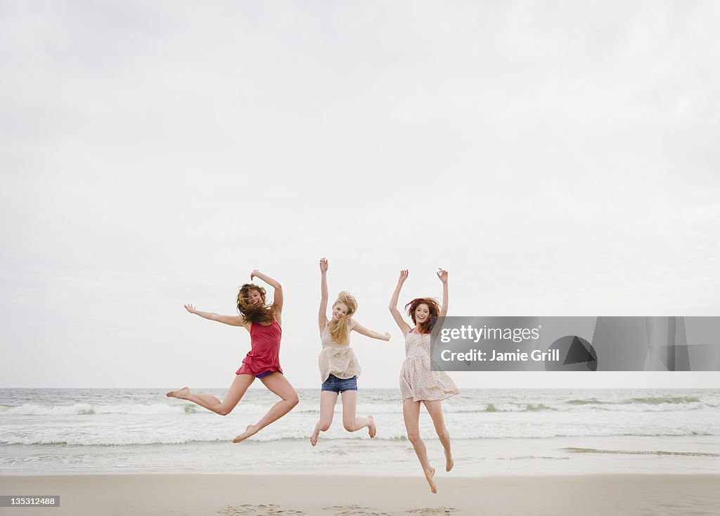 Women jumping at beach