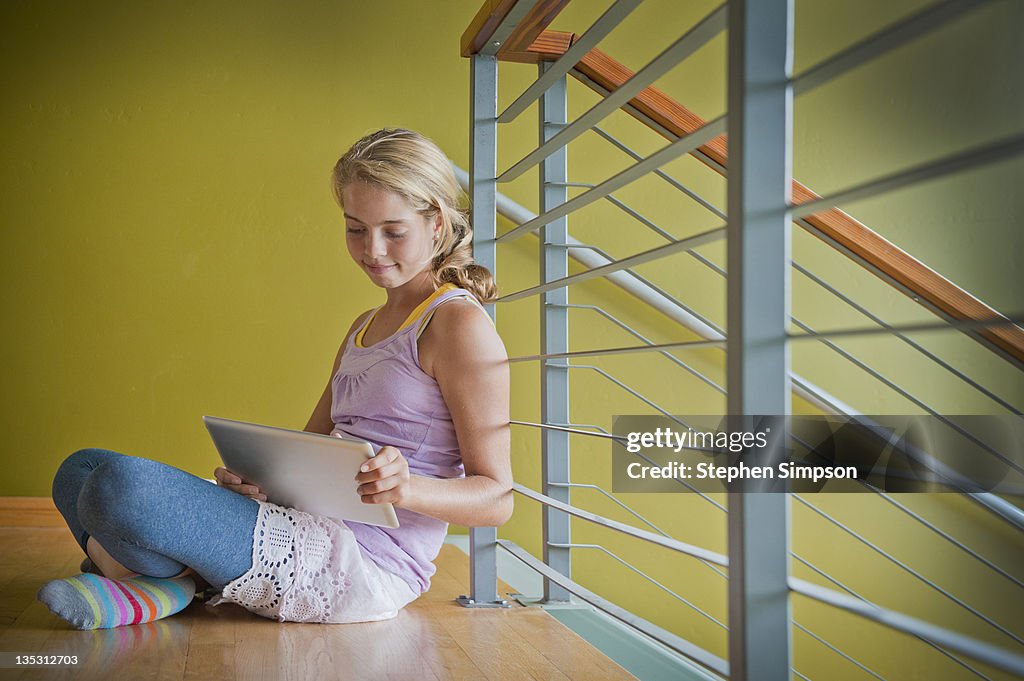 Teen girl on the floor with tablet computer