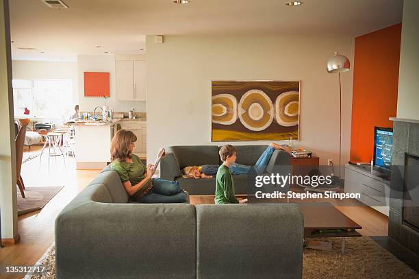 living room, family at home - boy watching tv stock pictures, royalty-free photos & images