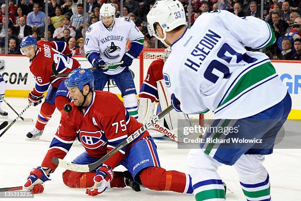 Hal Gill of the Montreal Canadiens blocks the puck on a shot by Henrik Sedin of the Vancouver Canucks during the NHL game at the Bell Centre on...