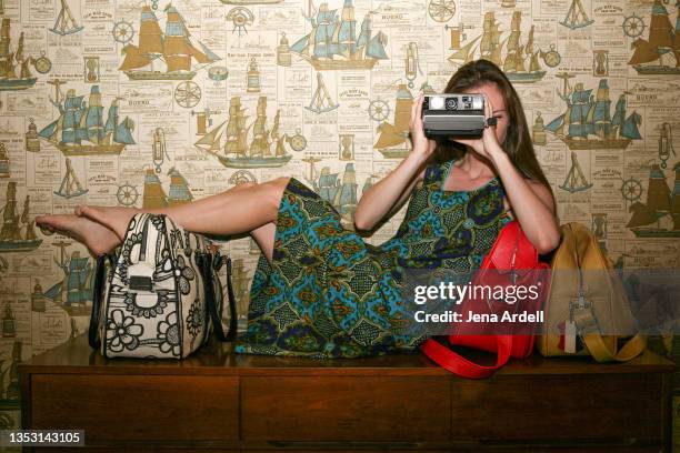 retro tourist woman taking photo, 1970s style, vintage style - woman fashion long dress stock pictures, royalty-free photos & images