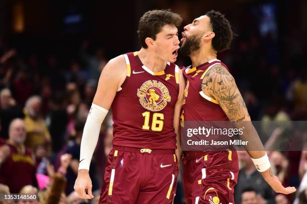 Cedi Osman and Denzel Valentine of the Cleveland Cavaliers celebrate after Osman scored during the fourth quarter against the Boston Celtics at...