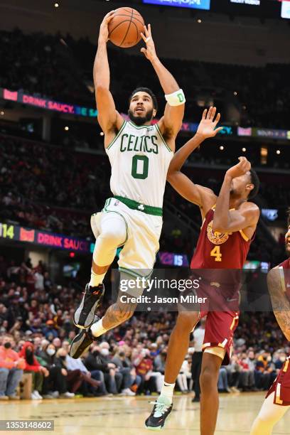 Jayson Tatum of the Boston Celtics shoots over Evan Mobley of the Cleveland Cavaliers during the fourth quarter at Rocket Mortgage Fieldhouse on...