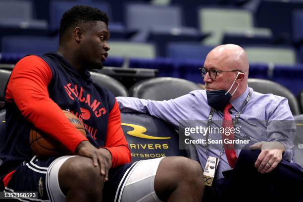 Zion Williamson of the New Orleans Pelicans speaks with David Griffin executive vice president of basketball operations for the New Orleans Pelicans...