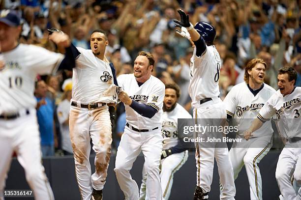 Playoffs: Milwaukee Brewers Carlos Gomez victorious with Mark Kotsay and teammates after scoring game-winning run to win series vs Arizona...