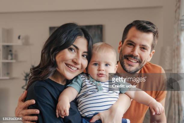 portrait of young family with toddler - young family with baby stock pictures, royalty-free photos & images