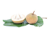 Whole and Half cut ripe Santol or Sentul fruit (Sandoricum koetjape) with leaf isolated on white background.