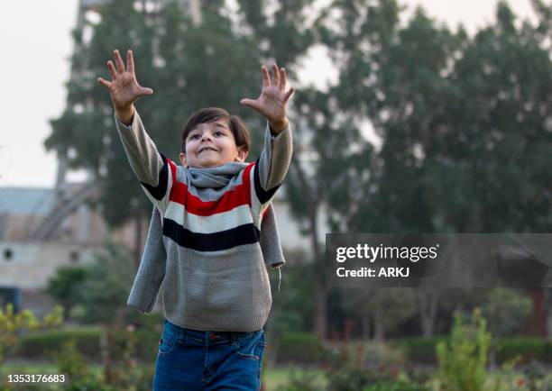 little young boy playing(smiling face)2 - pakistani boys stockfoto's en -beelden