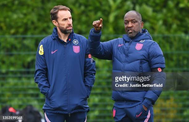 Gareth Southgate, Manager of England speaks to Chris Powell, Coach of England during the England Training Session at St George's Park on November 14,...