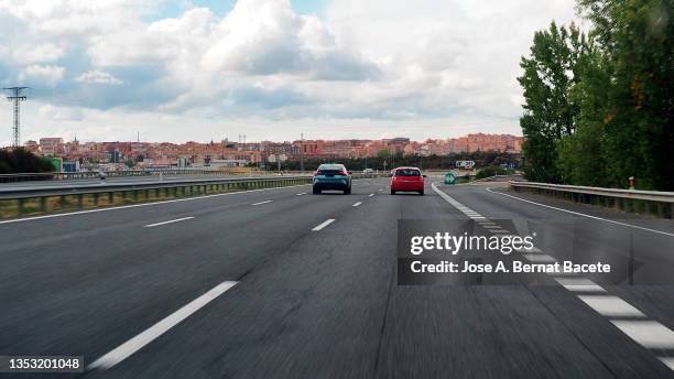 car point of view driving, cars driving on a highway heading into the city. - townscape stock pictures, royalty-free photos & images