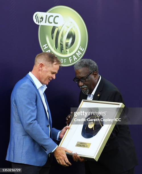 Shaun Pollock is presented with a ICC hall of fame cap from Clive Lloyd during the ICC Men's T20 World Cup final match between New Zealand and...