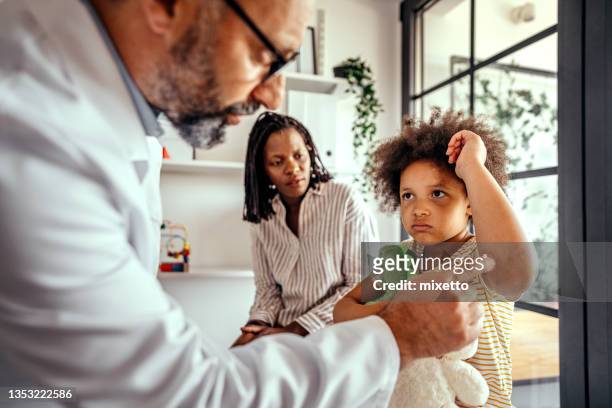 mother and daughter at pediatrician's office - dermatology stock pictures, royalty-free photos & images