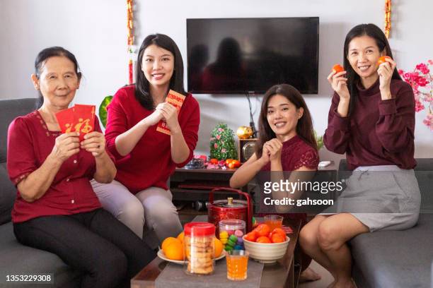 joyful people having fun and celebrating chinese new year - 30 year old portrait in house stockfoto's en -beelden