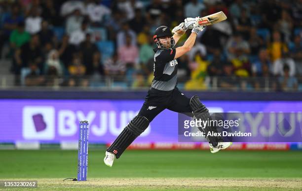 Kane Williamson of New Zealand drives the ball while batting during the ICC Men's T20 World Cup final match between New Zealand and Australia at...