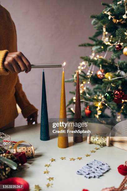 woman lighting christmas candles - green lighter stock pictures, royalty-free photos & images