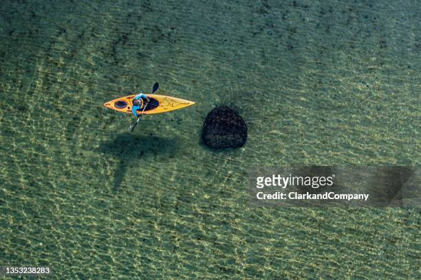 sea kayaking in the baltic sea - rowboat stockfoto's en -beelden