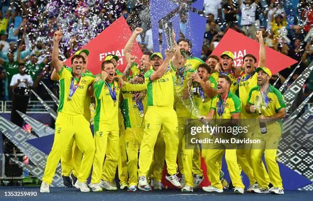 Aaron Finch of Australia poses with the ICC Men's T20 World Cup Trophy with his team mates following the ICC Men's T20 World Cup final match between...