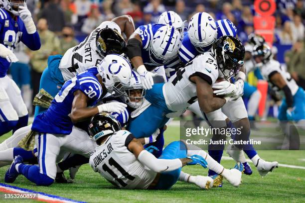 Carlos Hyde of the Jacksonville Jaguars is tackled by the Indianapolis Colts during the first half at Lucas Oil Stadium on November 14, 2021 in...