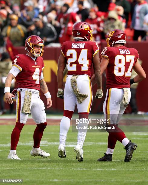 Taylor Heinicke of the Washington Football Team, John Bates and Antonio Gibson celebrate a touchdown during the first half against the Tampa Bay...