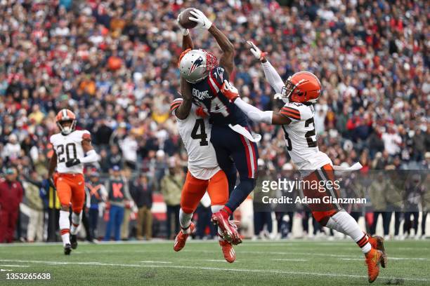 Kendrick Bourne of the New England Patriots completes a touchdown pass against Troy Hill of the Cleveland Browns during the second quarter at...