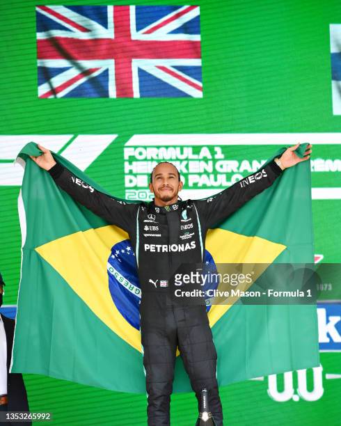 Race winner Lewis Hamilton of Great Britain and Mercedes GP celebrates on the podium during the F1 Grand Prix of Brazil at Autodromo Jose Carlos Pace...
