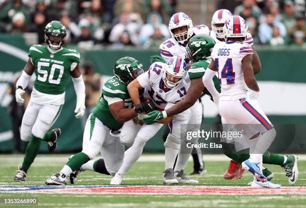 Josh Allen of the Buffalo Bills is tackled by Sheldon Rankins and Quinnen Williams of the New York Jets in the second quarter at MetLife Stadium on...