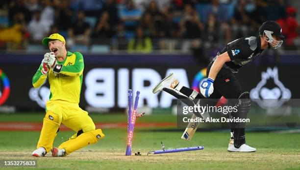 Matthew Wade of Australia attempts to run out Jimmy Neesham of New Zealand during the ICC Men's T20 World Cup final match between New Zealand and...