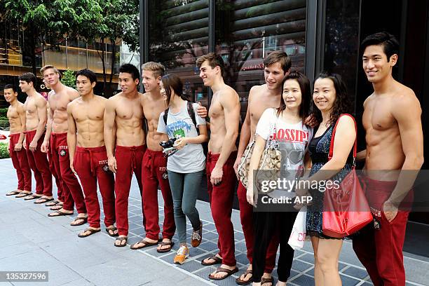 About 40 Abercrombie & Fitch models line outside the A&F store to take pictures with passers by in Knightsbridge, a Singapore shopping mall on...