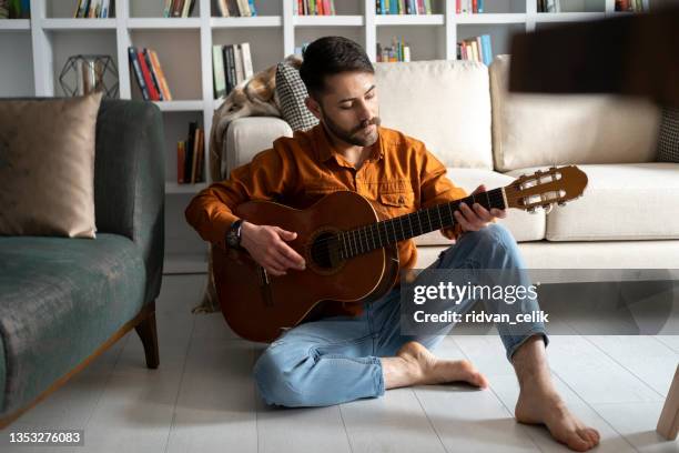 honing his musical talent - acoustic guitarist stock pictures, royalty-free photos & images