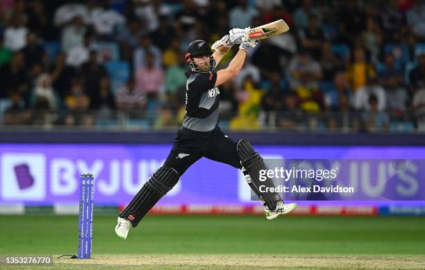 Kane Williamson of New Zealand drives the ball while batting during the ICC Men's T20 World Cup final match between New Zealand and Australia at...