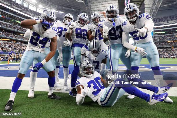 The Dallas Cowboys celebrate an interception by Trevon Diggs of the Dallas Cowboys against the Atlanta Falcons during the third quarter at AT&T...
