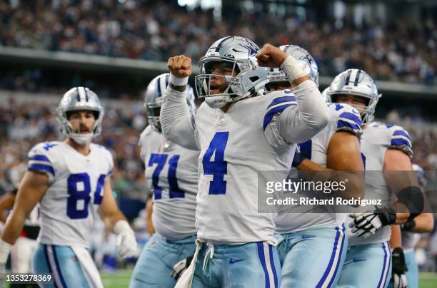 Dak Prescott of the Dallas Cowboys celebrates his rushing touchdown against the Atlanta Falcons during the third quarter at AT&T Stadium on November...